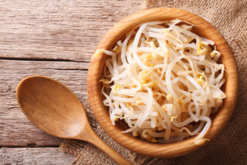 Poster - sprouts of mung beans in a wooden bowl. horizontal top view 
