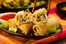 Portion Baked Spring Rolls With Vegetables And Rice On A Plate.