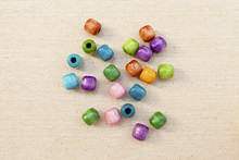 Colorful Wooden Beads On Canvas Background