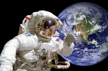 Wall Mural - close up of an astronaut in outer space, earth in the background - elements of this image are provid