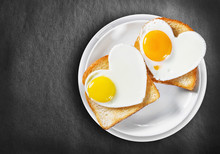 Two Heart-shaped Fried Eggs And Fried Toast