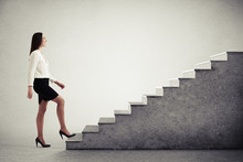 Woman Walking Up Concrete Stairs