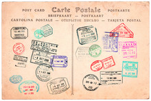 Collection Of Passport Stamps On A Vintage Postcard Background