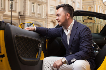 Stylish man sitting in sport car