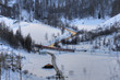 Photography of a train intersecting a river and a road on winter
