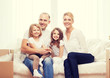 © Syda Productions - smiling parents and two little girls at new home