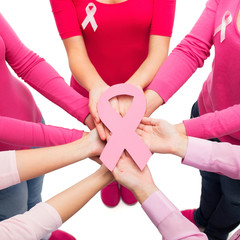 Wall Mural - close up of women with cancer awareness ribbons