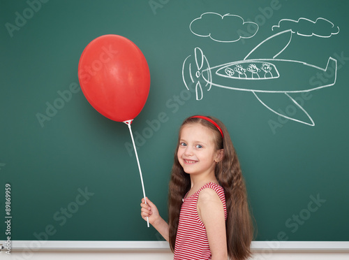 girl with balloon drawing plane on school board Poster