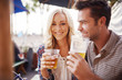 © Joshua Resnick - romantic couple drinking beer together in outdoor beach side pub or bar