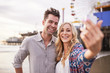 © Joshua Resnick - romantic couple taking selfie together on the beach in santa monica california