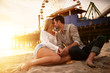 © Joshua Resnick - romantic couple about to kiss on santa monica beach with lens flare. Shot with selective focus