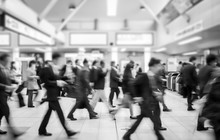 Business People Walking In The Subway Station. Motion Blurred Black And White Filter