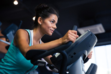 Wall Mural - Woman workout on exercises machine