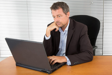 Wall Mural - Man with Beard Working on Laptop isolated on a White Background