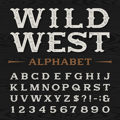 Wall Mural - Western style retro distressed alphabet vector font. Serif type dirty letters, numbers and symbols on a dark wood textured background. Vintage vector typography for labels, headlines, posters etc.