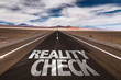 Reality Check written on desert road