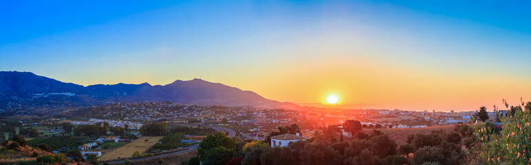 Wall Mural - Mountain And Sunset at Mijas, Spain. Mountains on Yellow Sunrise