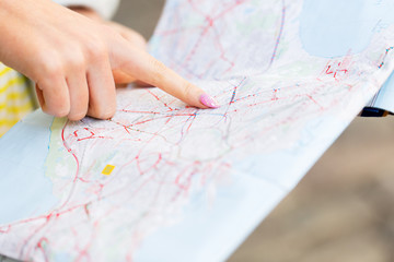 close up of woman hand pointing finger to map