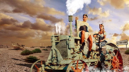 Two sexy woman in the steam-punk clothes are driving vintage tra