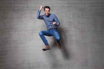 euphoric business man jump wall