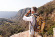 © michaeljung - middle aged male hiker using binoculars