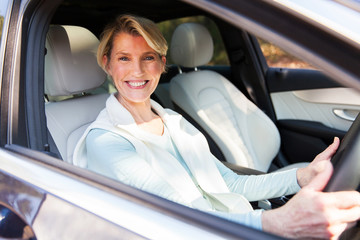 middle aged woman driving a car