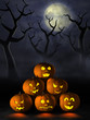 Stack of Halloween pumpkins in a spooky forest at night
