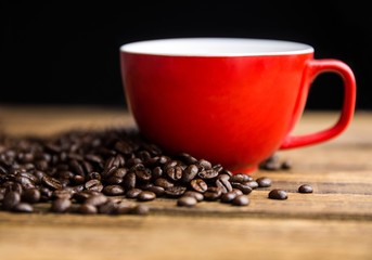 Poster - Coffee beans on a table with cup