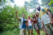 © Syda Productions - happy friends with backpacks and tablet pc hiking