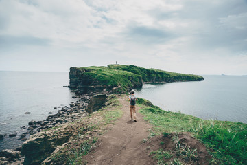 Canvas Print - Traveler girl walking on island in summer