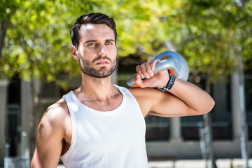 Poster - Handsome athlete outfit with a kettlebell