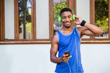 Poster -  An handsome athlete listening to music