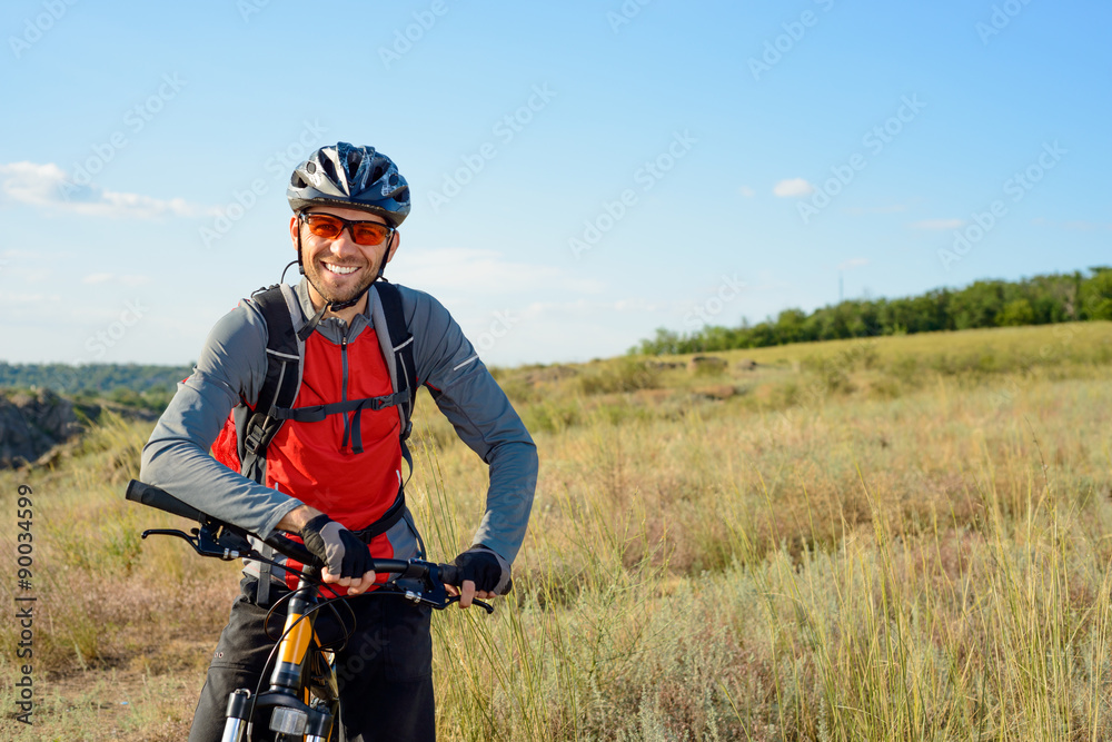 Portrait of Young Cyclist in Helmet and Glasses - obrazy, fototapety, plakaty 