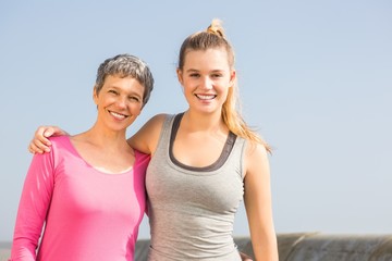 Wall Mural - Sporty mother and daughter smiling