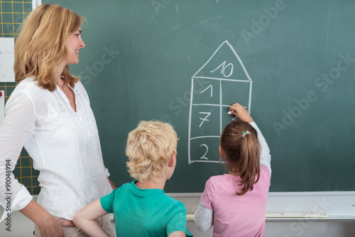 Lehrerin Unterstutzt Kinder Beim Rechnen An Der Tafel Buy This Stock Photo And Explore Similar Images At Adobe Stock Adobe Stock