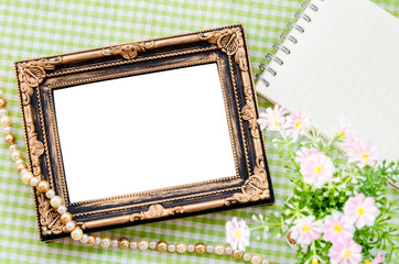 Old vintage photo frame with open diary