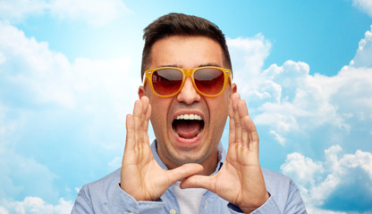 Wall Mural - face of angry shouting man in shirt and sunglasses