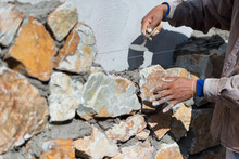 Close-up Of Construction Process Mason Workers Masonry Clay Old Brick To Wall