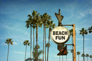 Wall Mural - aged and worn vintage photo of beach fun sign with palm trees