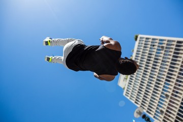 Poster - Athletic man doing back flip in the city