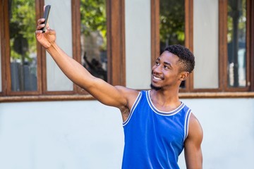 Poster -  An happy handsome athlete taking a selfie