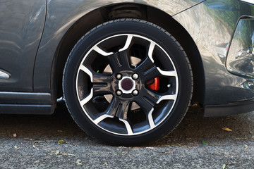 Wall Mural - Wheel of modern car on black steel disc