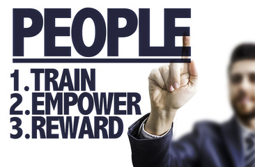 Businessman pointing the text: People 1-Train 2-Empower 3-Reward