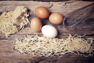 Canvas Print - Making noodles with egg and whisk