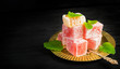 © colnihko - Turkish delight on oriental metal plate on black background. Concept of oriental sweets with space for text