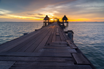 Wall Mural - Wooded bridge in the port and sunset