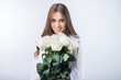 © fotoplaton - Young girl with a bouquet white roses