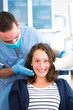 © Production Perig - Young attractive dentist doing a radiography of woman teeth