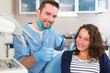 © Production Perig - Young attractive dentist explaning his work to a patient