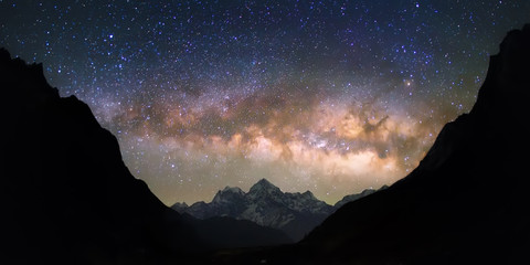 bowl of heavens. bright and vivid milky way galaxy over the snowy mountains. beautiful starry night 